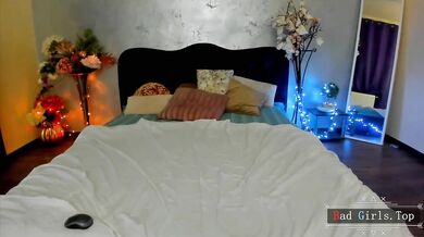 Prsatá webkamerová kočka provokuje na posteli v průsvitném bílém prádle